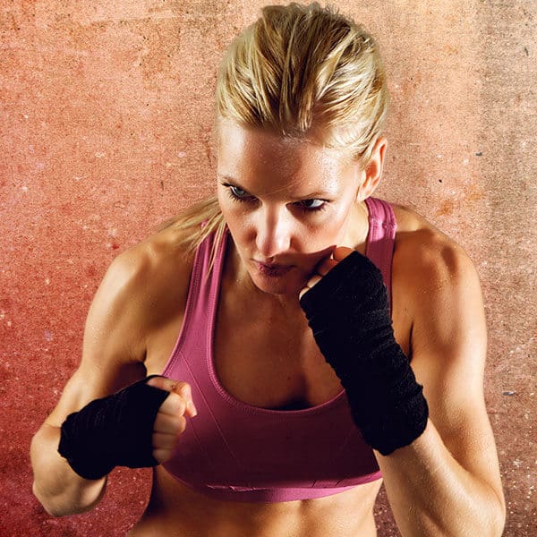Mixed Martial Arts Lessons for Adults in Shawnee KS - Lady Kickboxing Focused Background