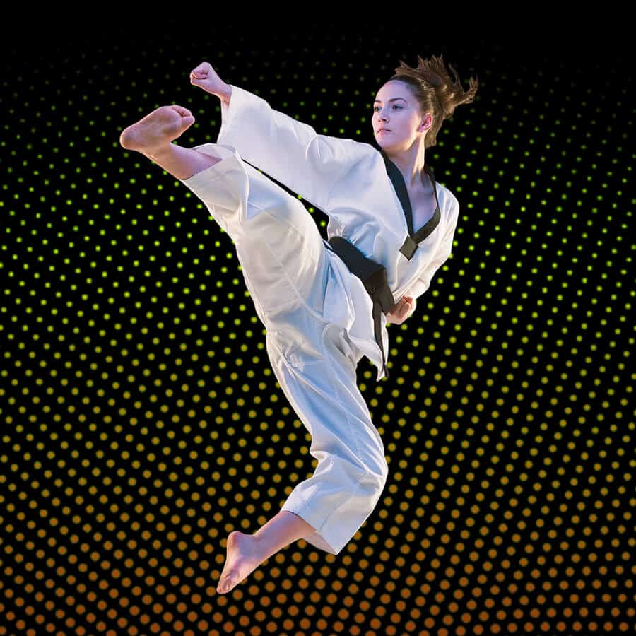 Martial Arts Lessons for Adults in Shawnee KS - Girl Black Belt Jumping High Kick