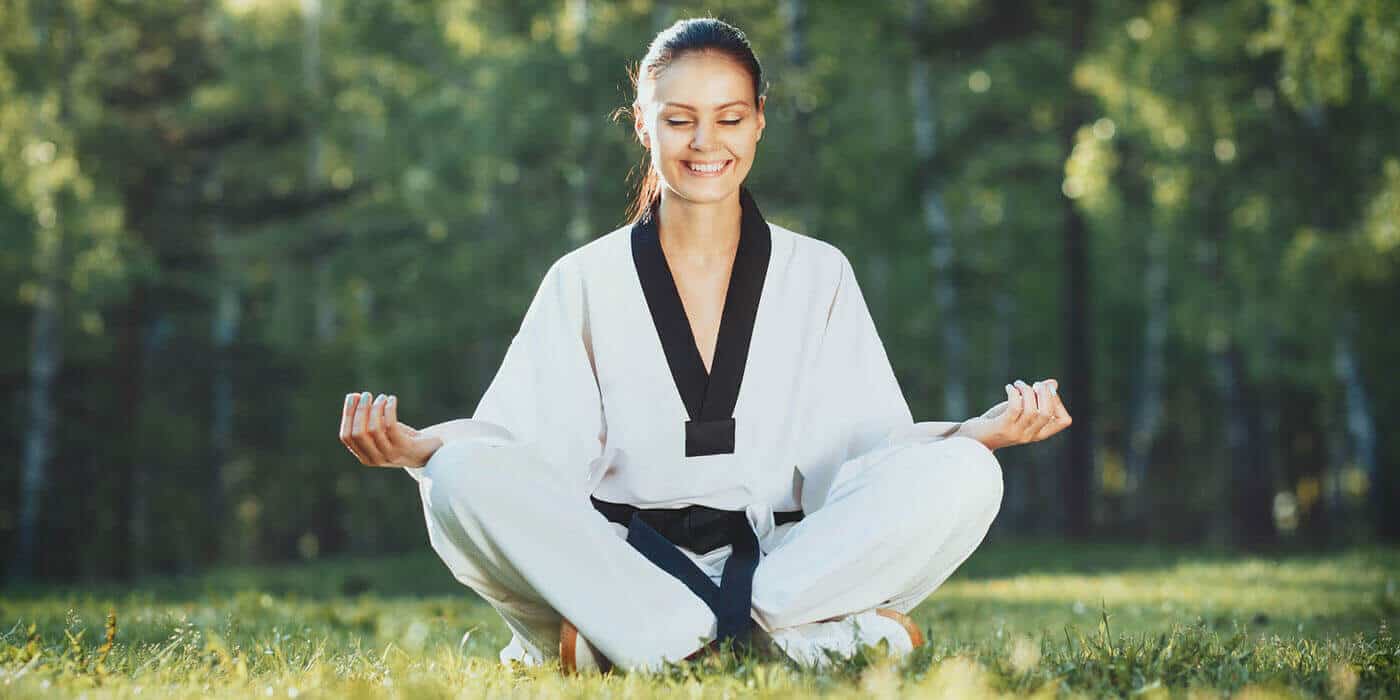 Martial Arts Lessons for Adults in Shawnee KS - Happy Woman Meditated Sitting Background